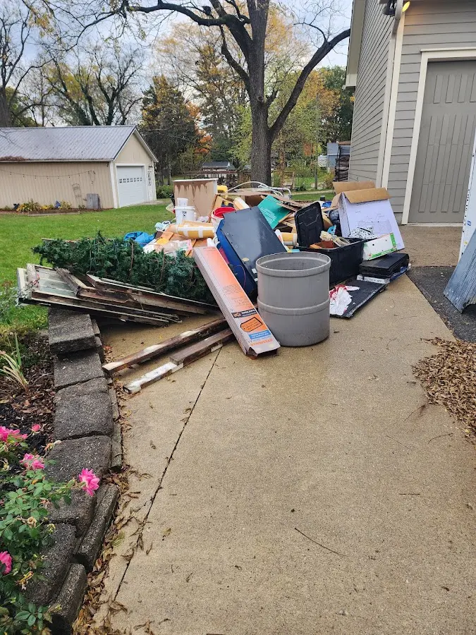 Dumpster being loaded with debris for Residential Dumpster Rental in Bakersfield